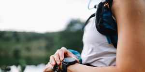 young woman using a smart watch during the hiking trip