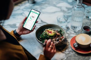 young woman using meal planning mobile app for a healthy diet