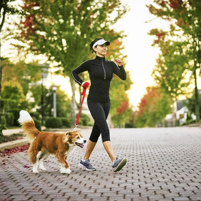 walking workouts for runners, young woman walking dog