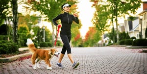 walking workouts for runners, young woman walking dog