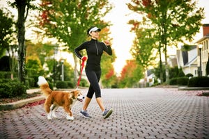 young woman walking dog