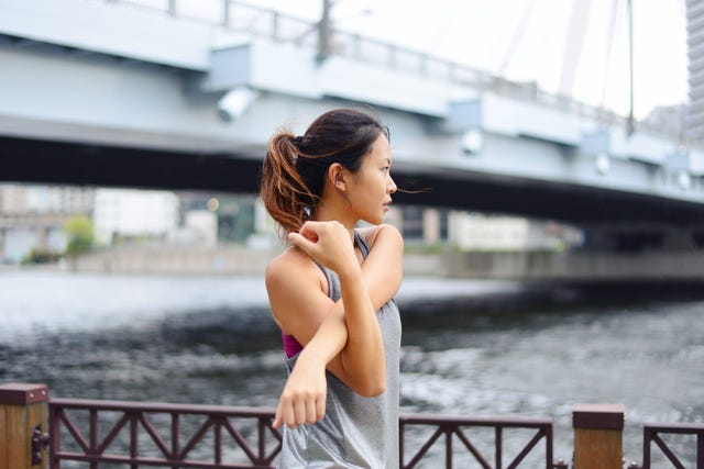 young woman warming up before her evening run