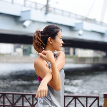 young woman warming up before her evening run