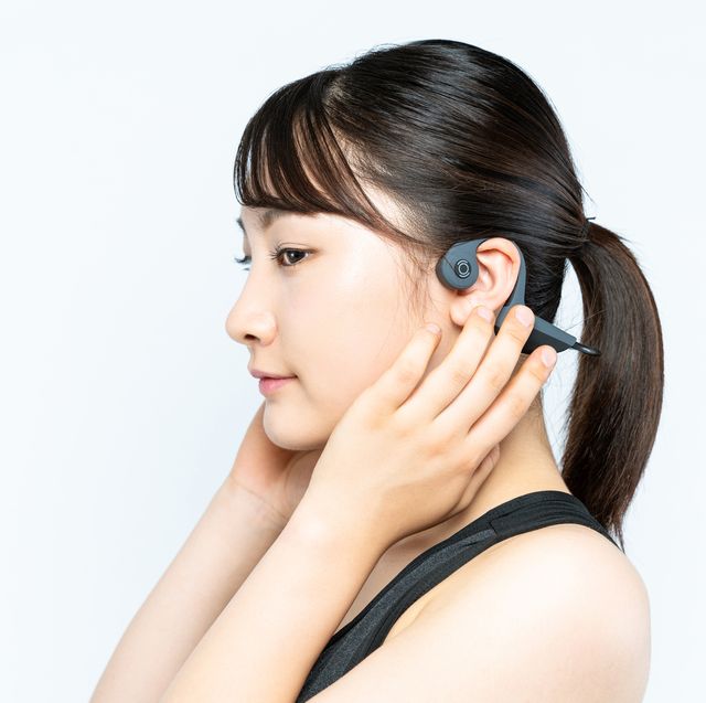 young woman wearing a bone conduction headphones