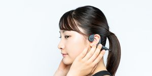young woman wearing a bone conduction headphones