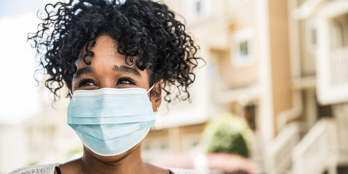 young woman wearing surgical mask in front of home best disposable face masks