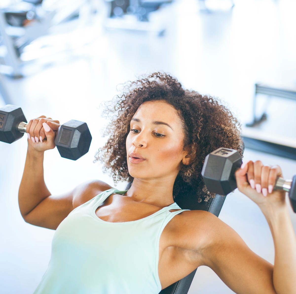 young woman weightraining at the gym