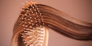 young woman with comb brushing her blonde hair