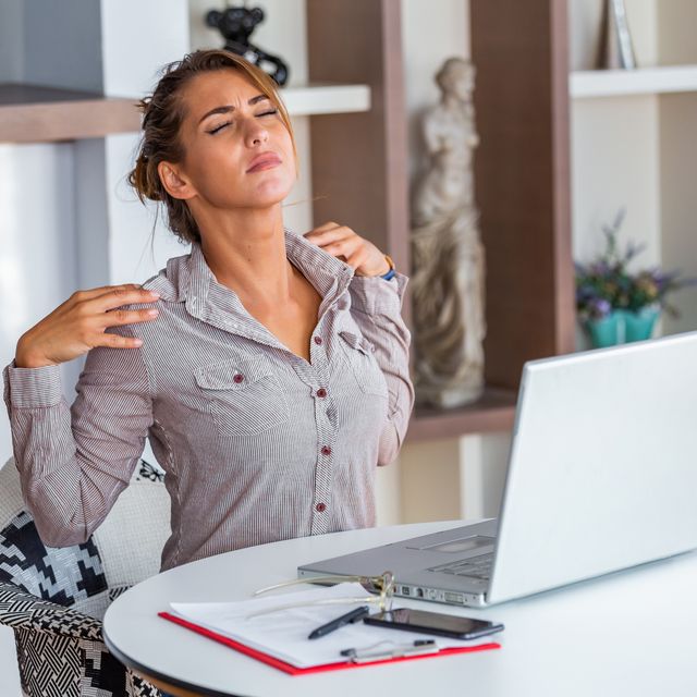 young woman with hands holding her shoulder pain office syndrome and health care concept business woman working with her laptop and with shoulder pain in the office