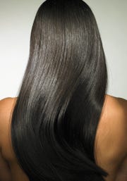 young woman with long hair, rear view