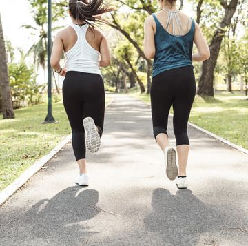 young women running together at the park