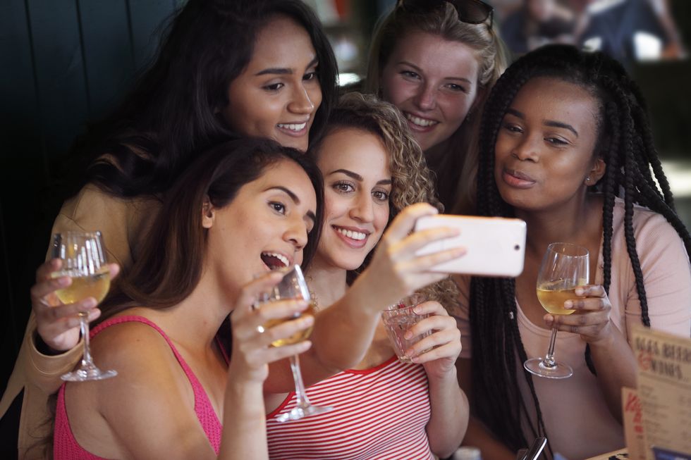 Young women taking selfie in restaurant