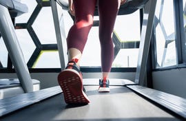 young women walking and running in the treadmill at the gym