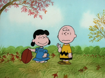 lucy and charlie brown with football