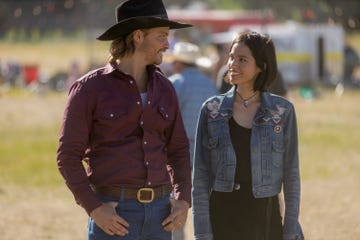 two individuals engaged in conversation outdoors dressed in casual attire