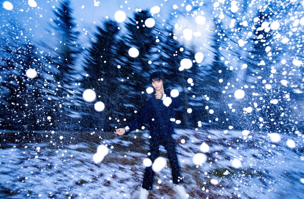 a person in a suit and tie surrounded by snow