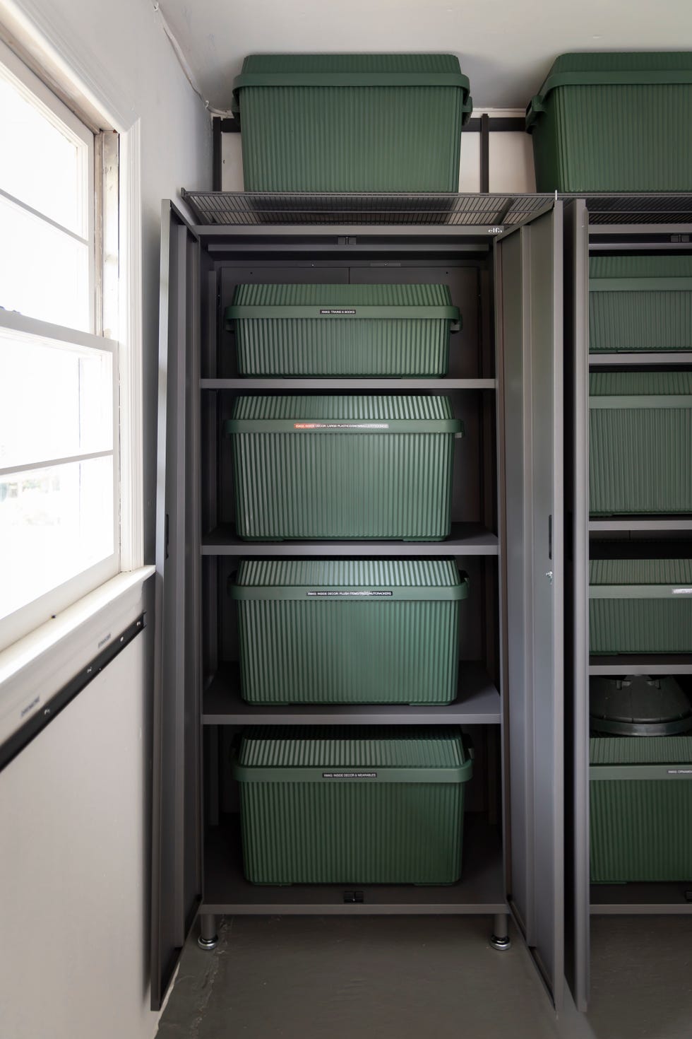 a shelf with green and white boxes
