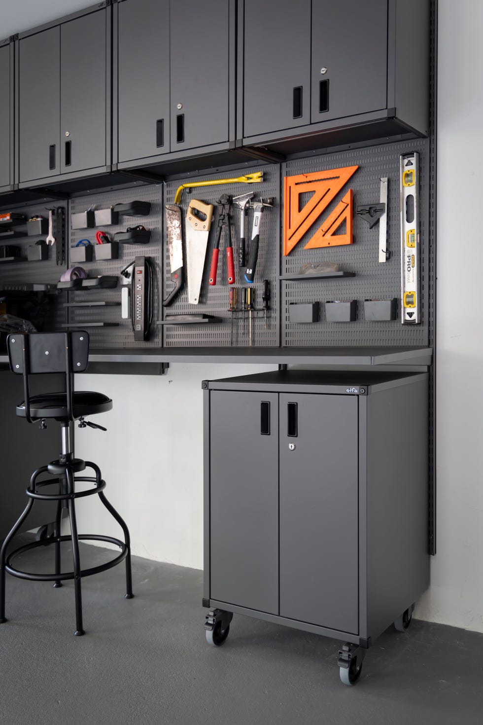 a black chair in front of a grey cabinet with a black chair