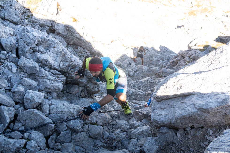a man climbing a rocky mountain