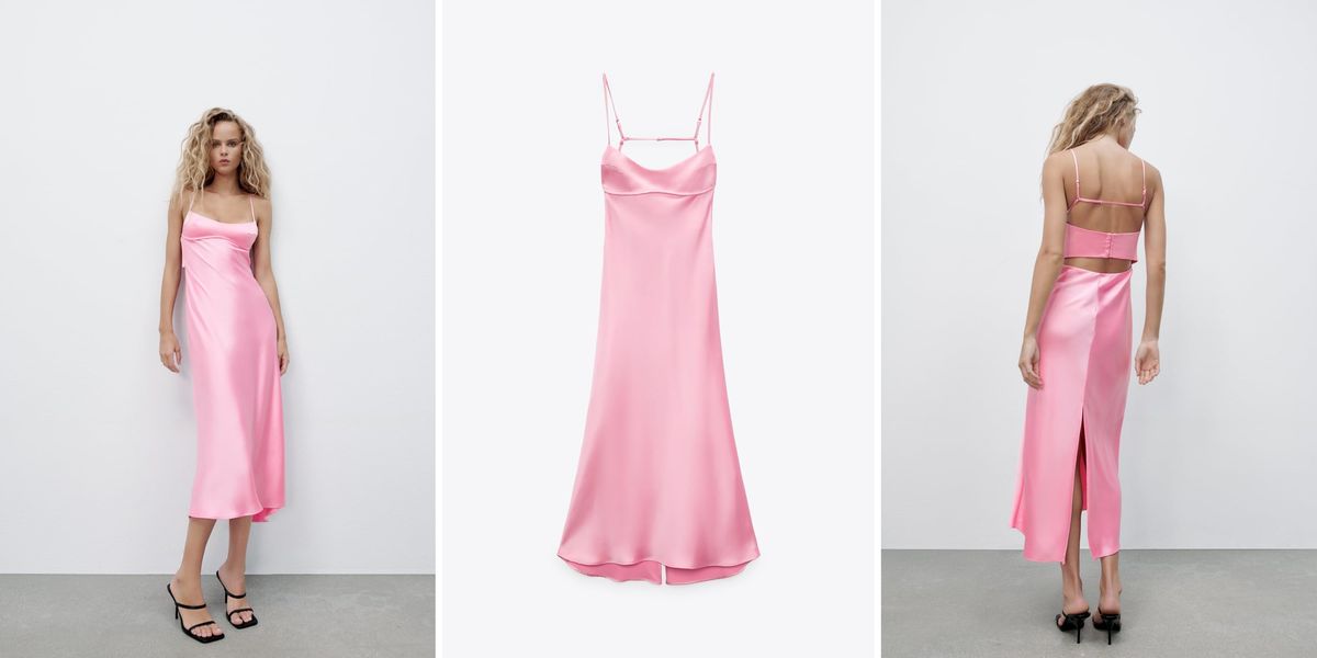 a model wears a zara pink satin slip dress that has gone viral on tiktok with back cut outs and a fluted hem