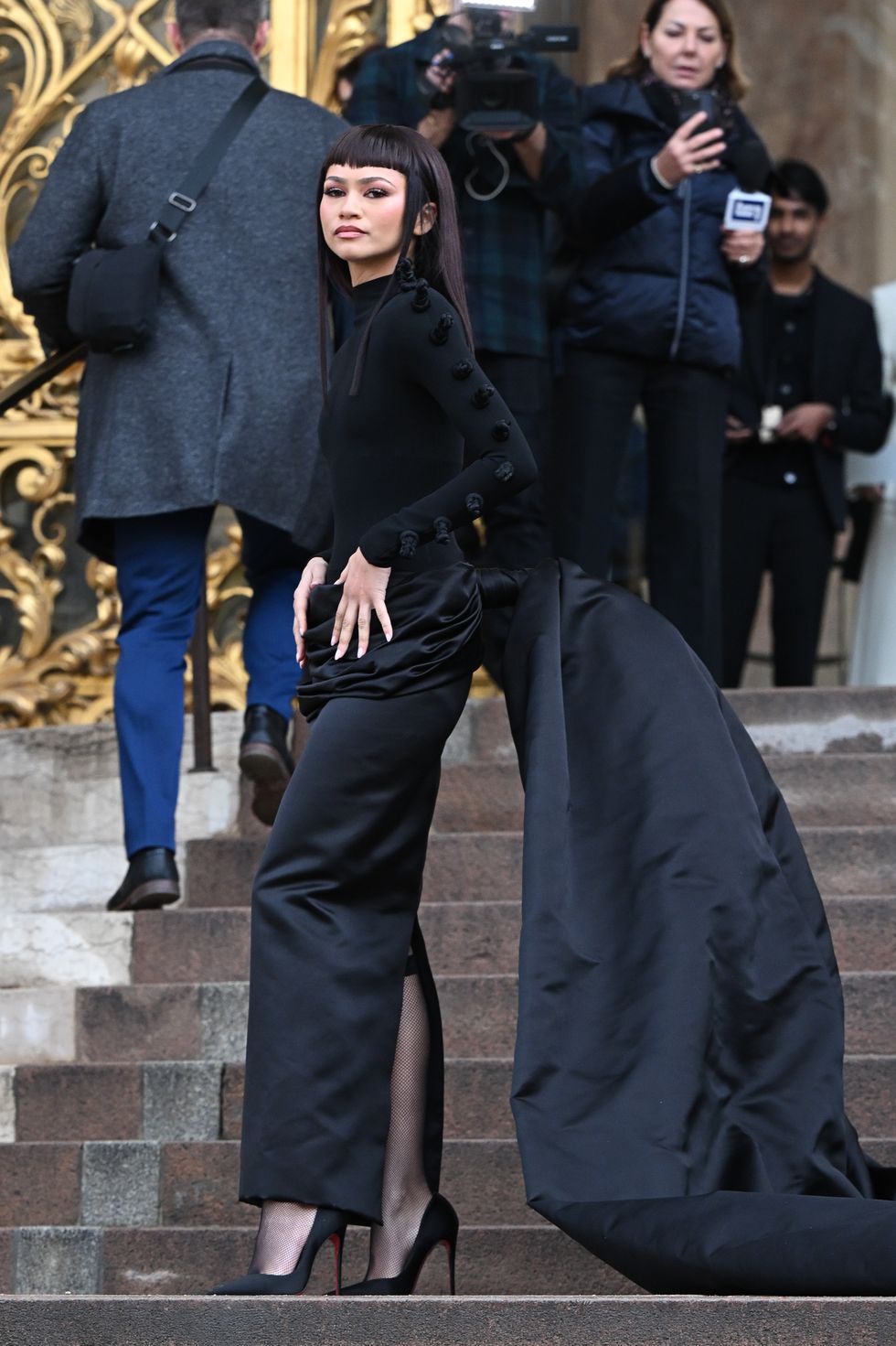 zendaya arriving at schiaparelli's paris fashion week haute couture spring summer 2024 wearing a satin skirt with dramatic train