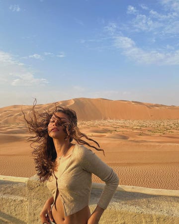a woman standing in a desert