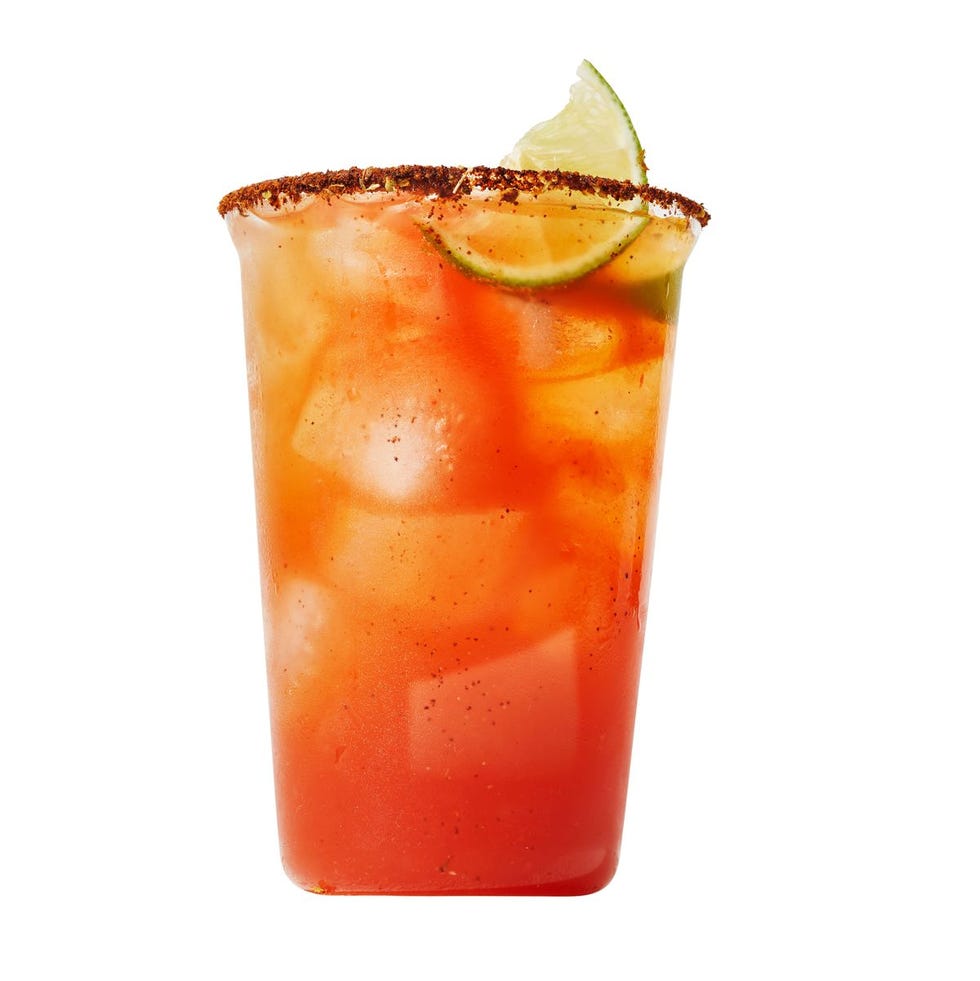 michelada cocktail with lime wedge and chile on the rim