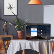 a monitor on a dining room table