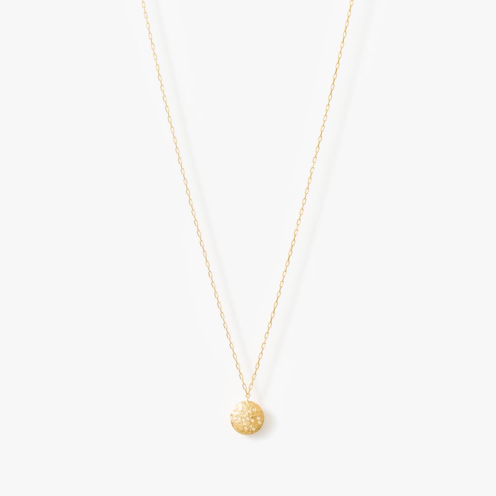 a gold necklace with a stone pendant