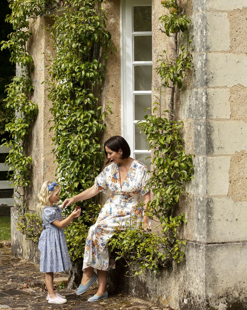 espaliered pear trees climb the windows of the orangery where zoë sits with her daughter ines 6