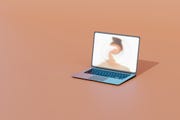 computer generated image of a laptop with blurred face on screen