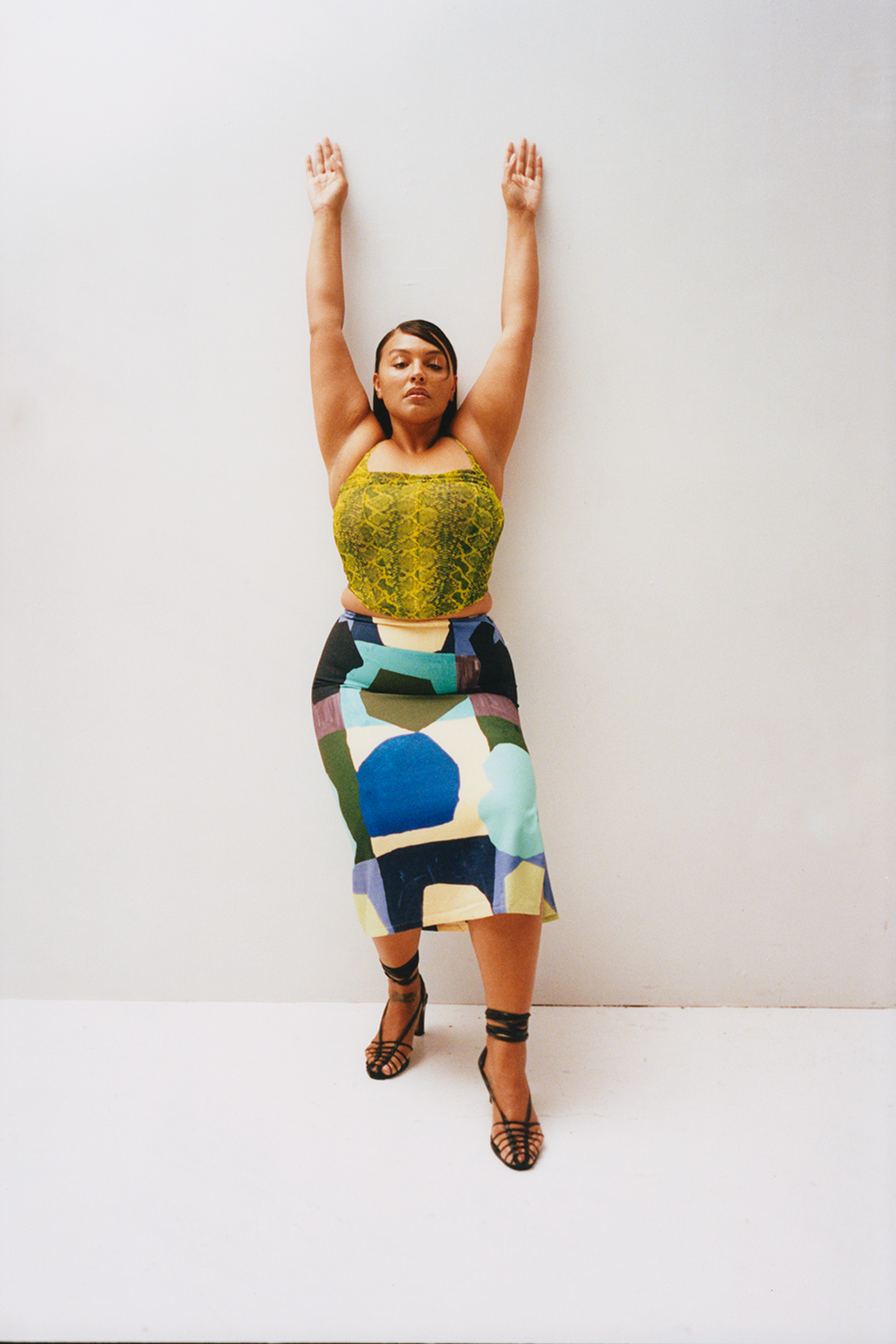 paloma elsesser stands in front of a plain backdrop while wearing a miaou top and skirt to illustrate a story about miaou extending sizes