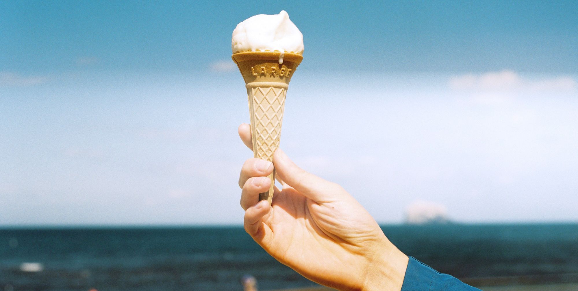 Ice cream cone, Sky, Frozen dessert, Cloud, Ice cream, Hand, Dairy, Vacation, Finger, Food, 