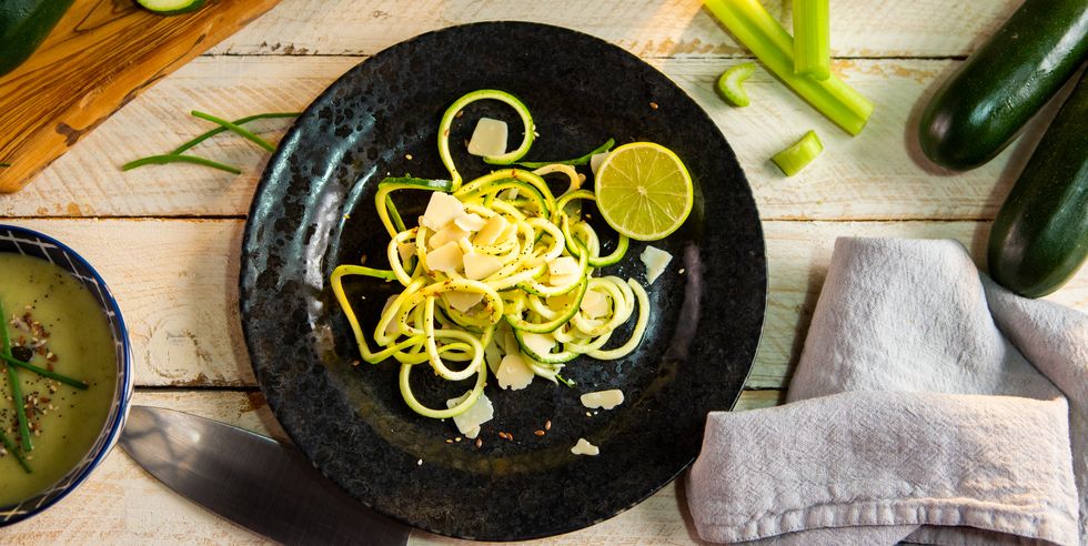 zucchini noodles with cheese and lime slice on plate