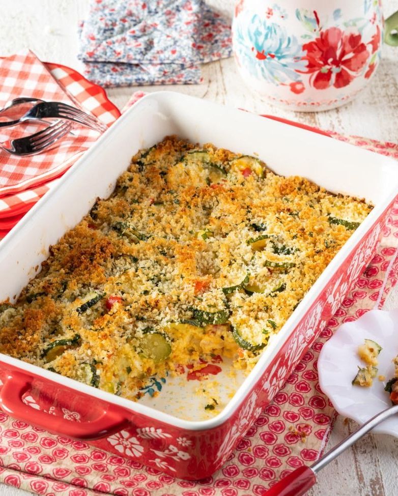 cheesy zucchini casserole in red baking dish