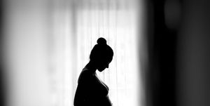Een zwart-wit foto van een zwangere vrouw