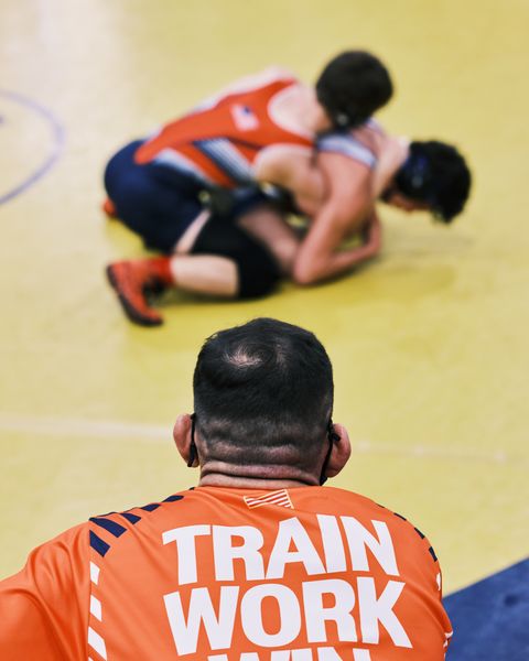 coach michael schyck watches one of his wrestlers compete in a county wrestling meet at charlotte high school in punta gorda, florida