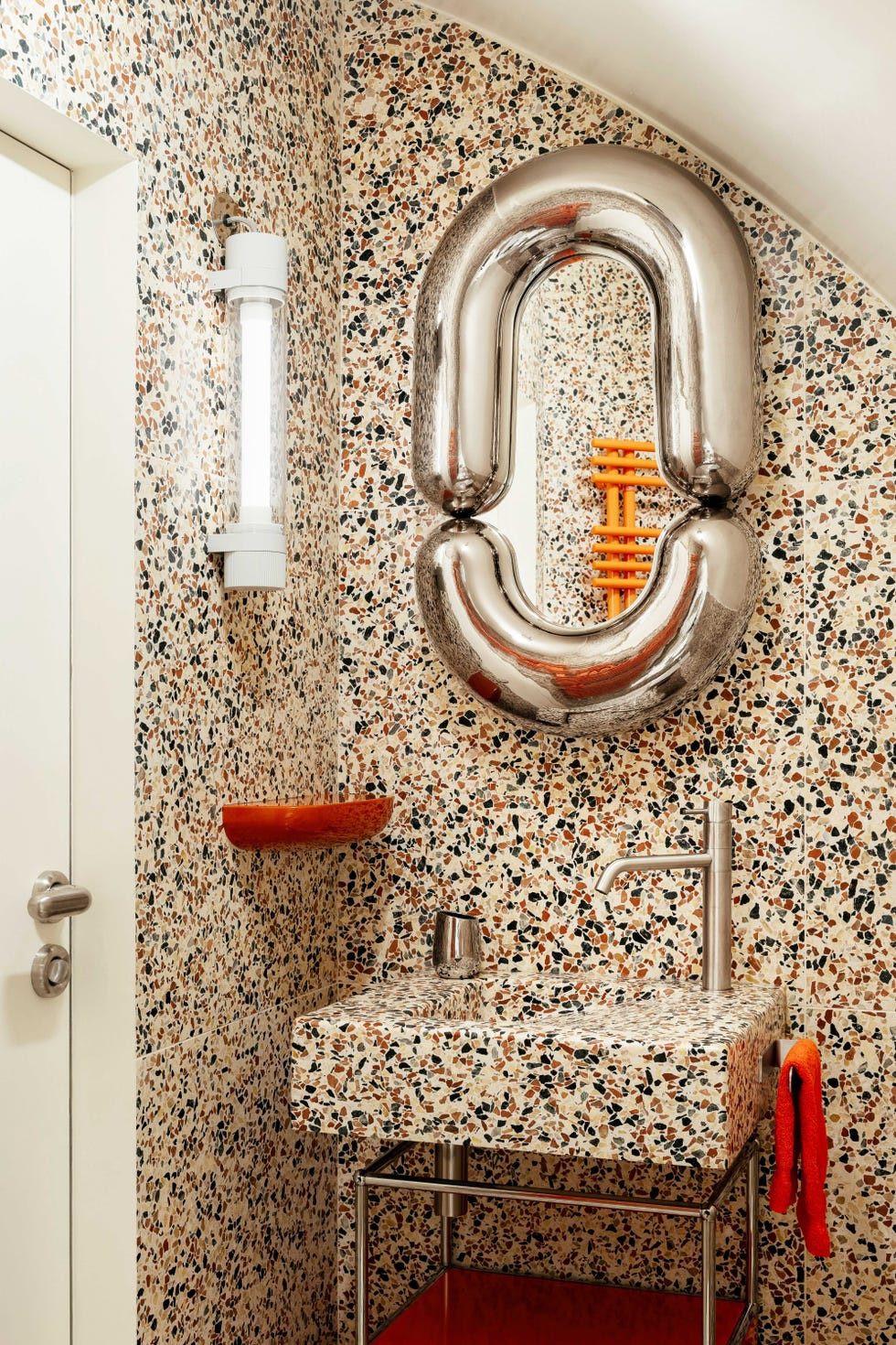 terrazzo orange and chrome bathroom