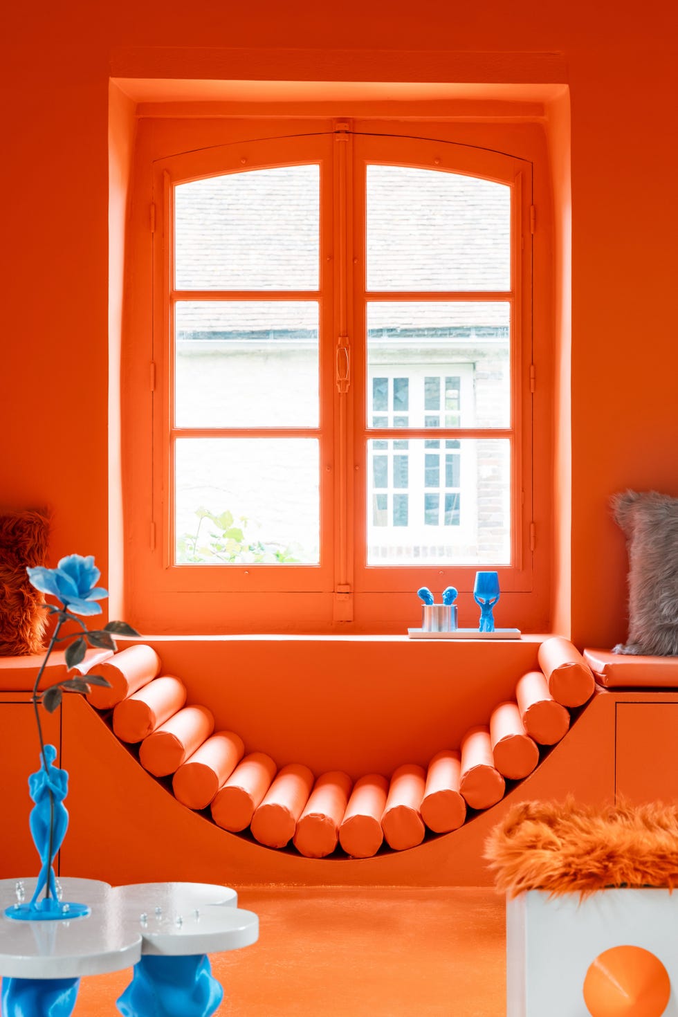 orange and blue office with built in daybed in front of window