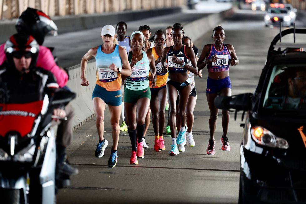 a large pack of elite women marathon runners heads over the queensboro bridge during the 2023 nyc marathon