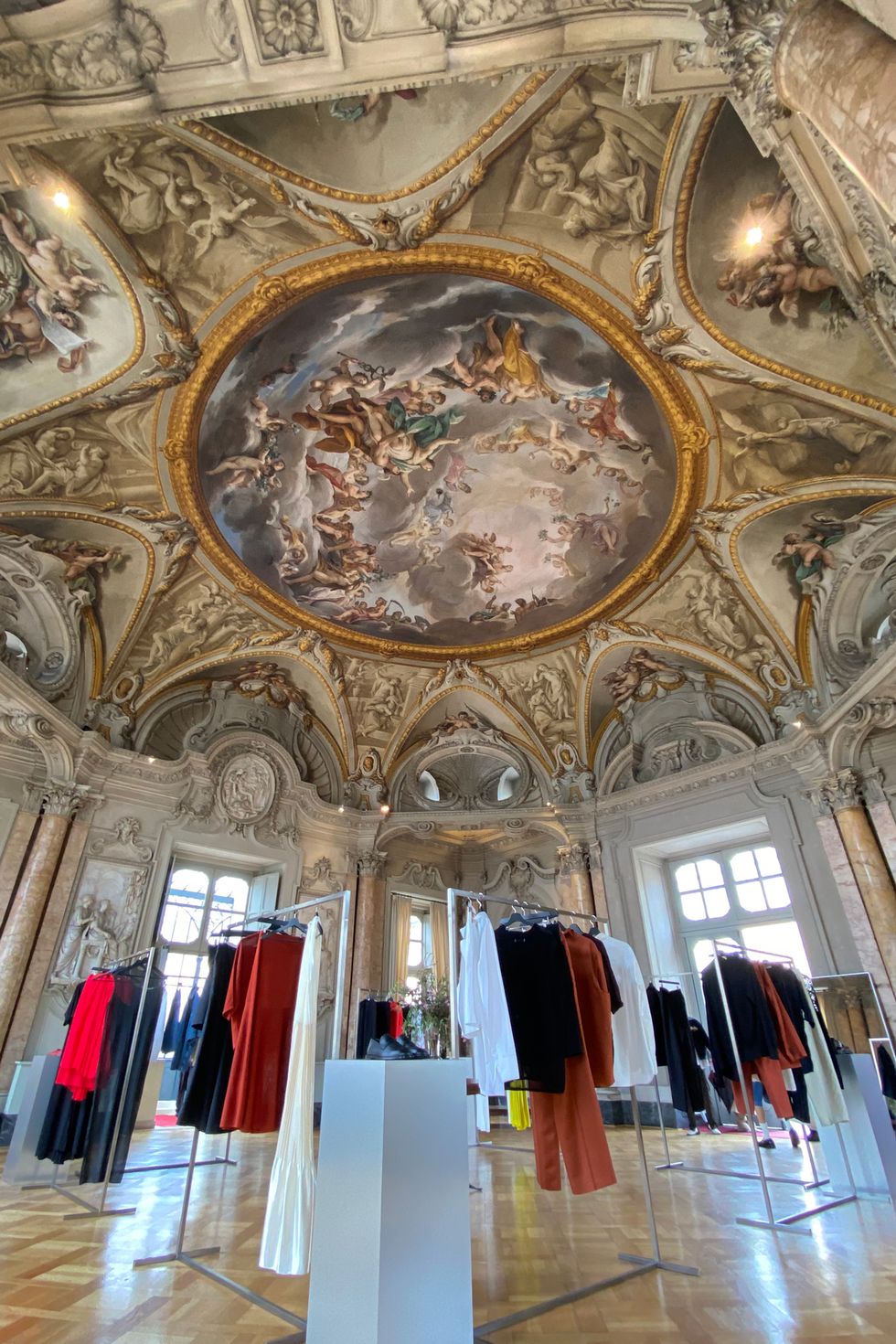 a room with a large ceiling and many clothes