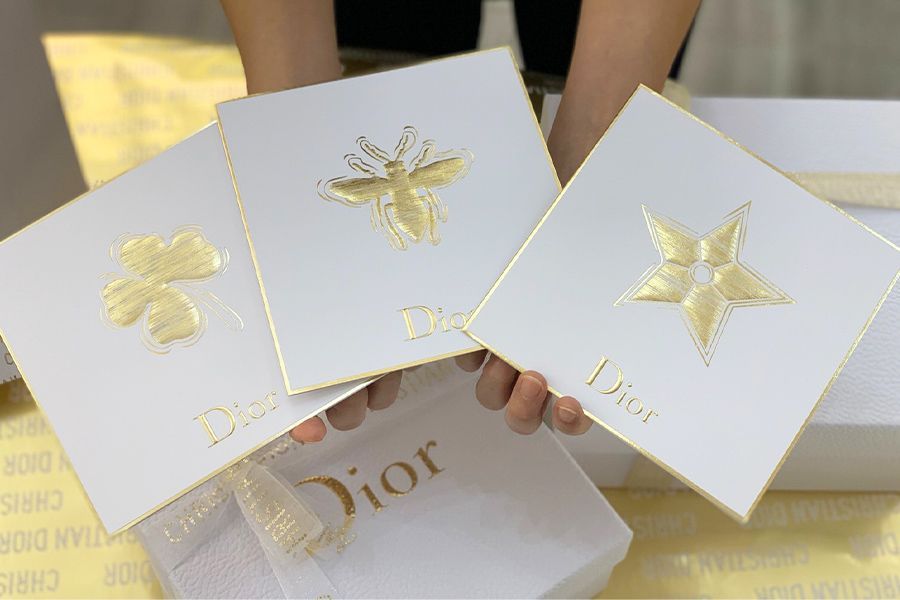 Leaf, Butterfly, Paper, Hand, Material property, Finger, Wedding favors, Paper product, Box, Party favor, 