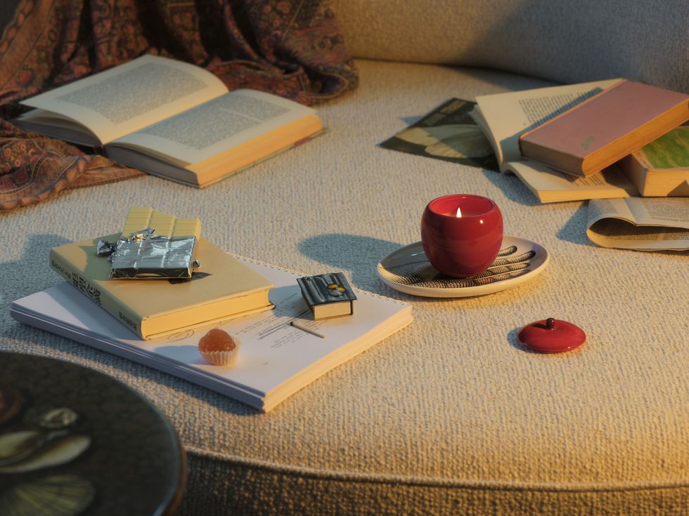 a table with books and a candle