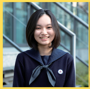 a person smiling and standing in front of a podium