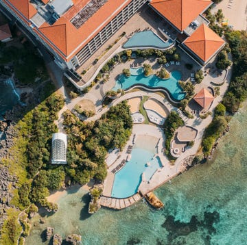 a large building with a pool in front of it