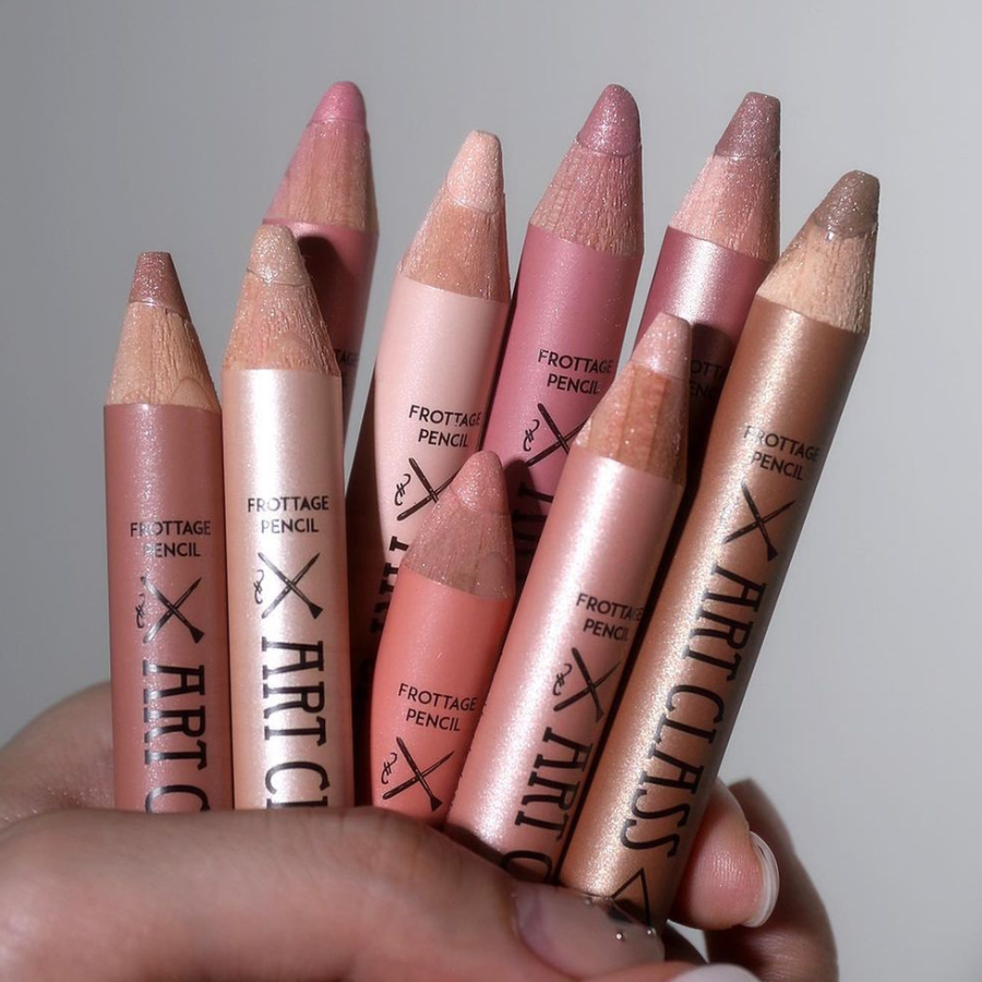 a hand holding a group of lipsticks