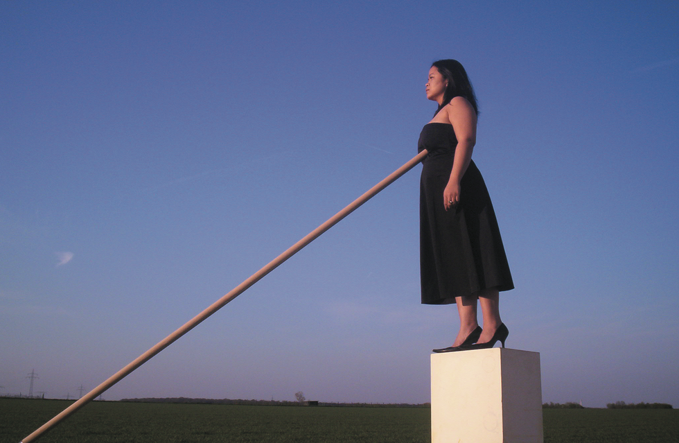 a person standing on a stone pillar