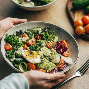 a person holding a plate of food