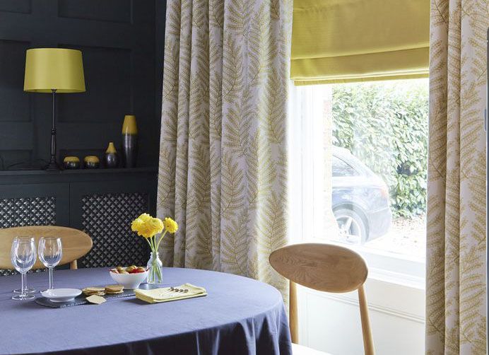 Yellow, Interior design, Room, Tablecloth, Stemware, Glass, Textile, Table, Furniture, Drinkware, 