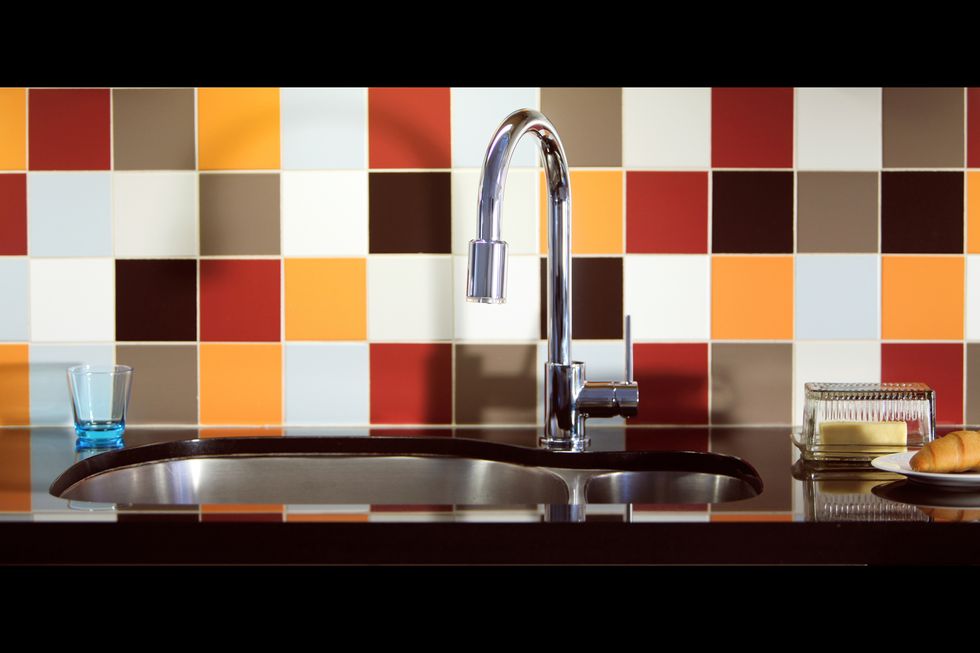 Modern kitchen sink with contrasting multicoloured tiles